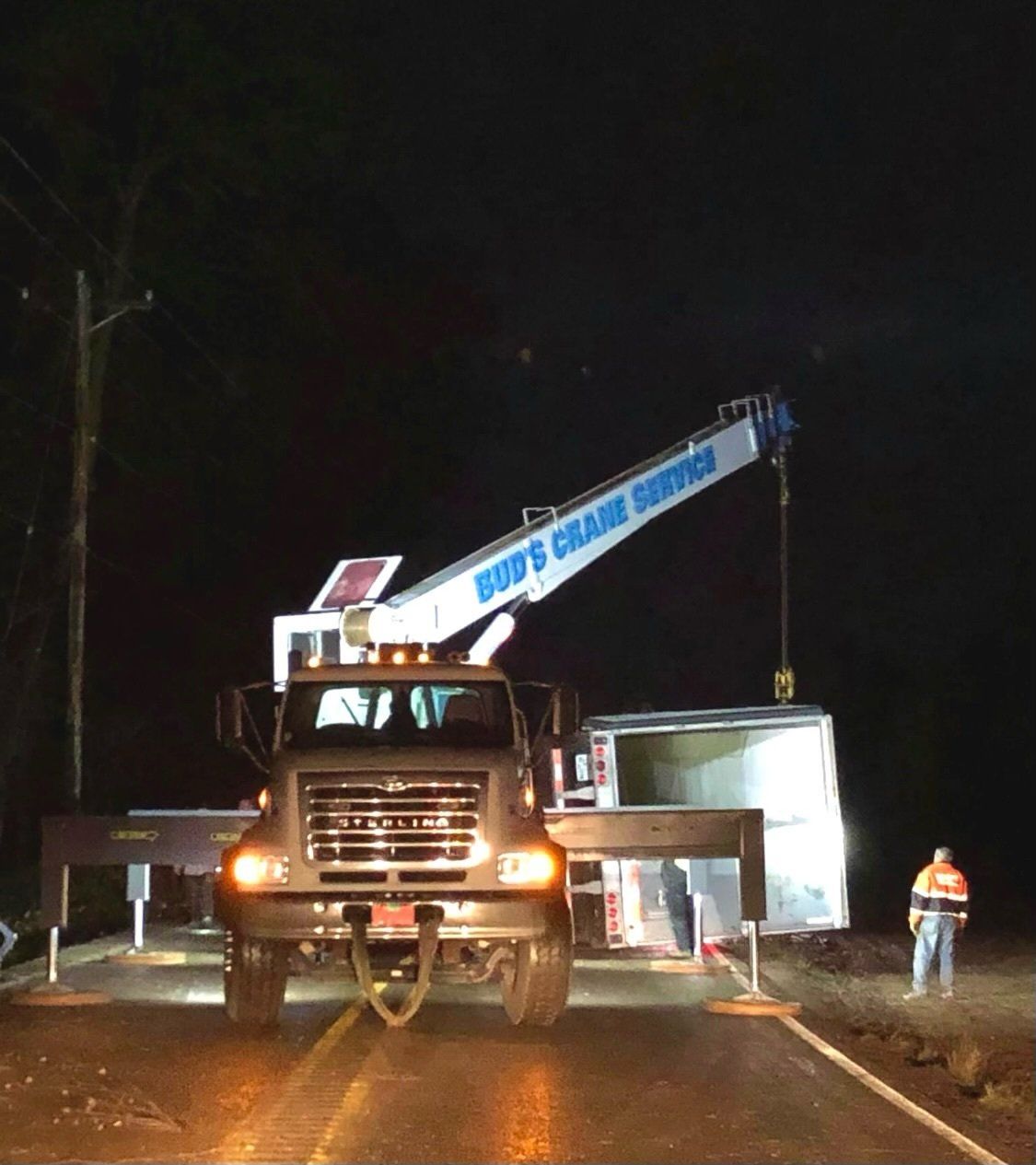 A crane lifting a truck on the side of the road — Oregon City, OR  — Bud's Crane Service Inc
