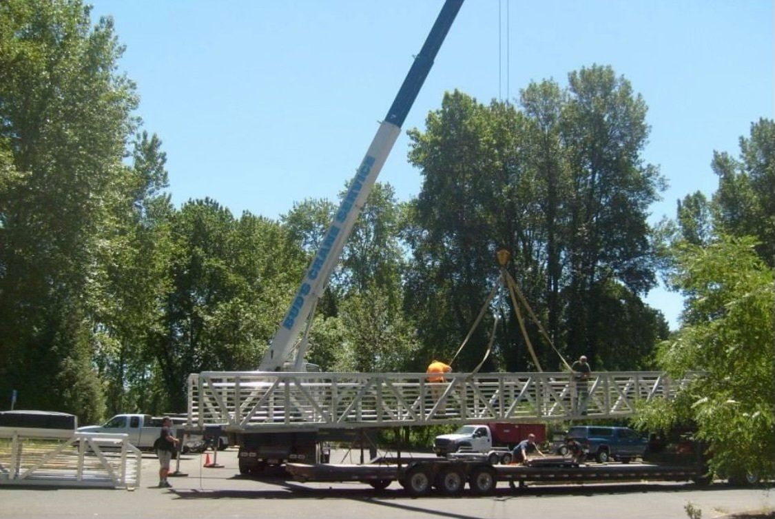 A crane lifting a large piece of material — Oregon City, OR  — Bud's Crane Service Inc