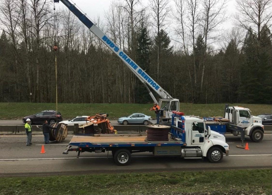 A crane lifting a cable drum — Oregon City, OR  — Bud's Crane Service Inc