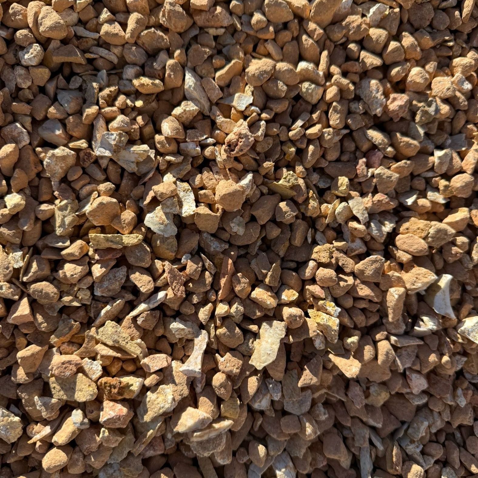 A pile of brown gravel is sitting on the ground