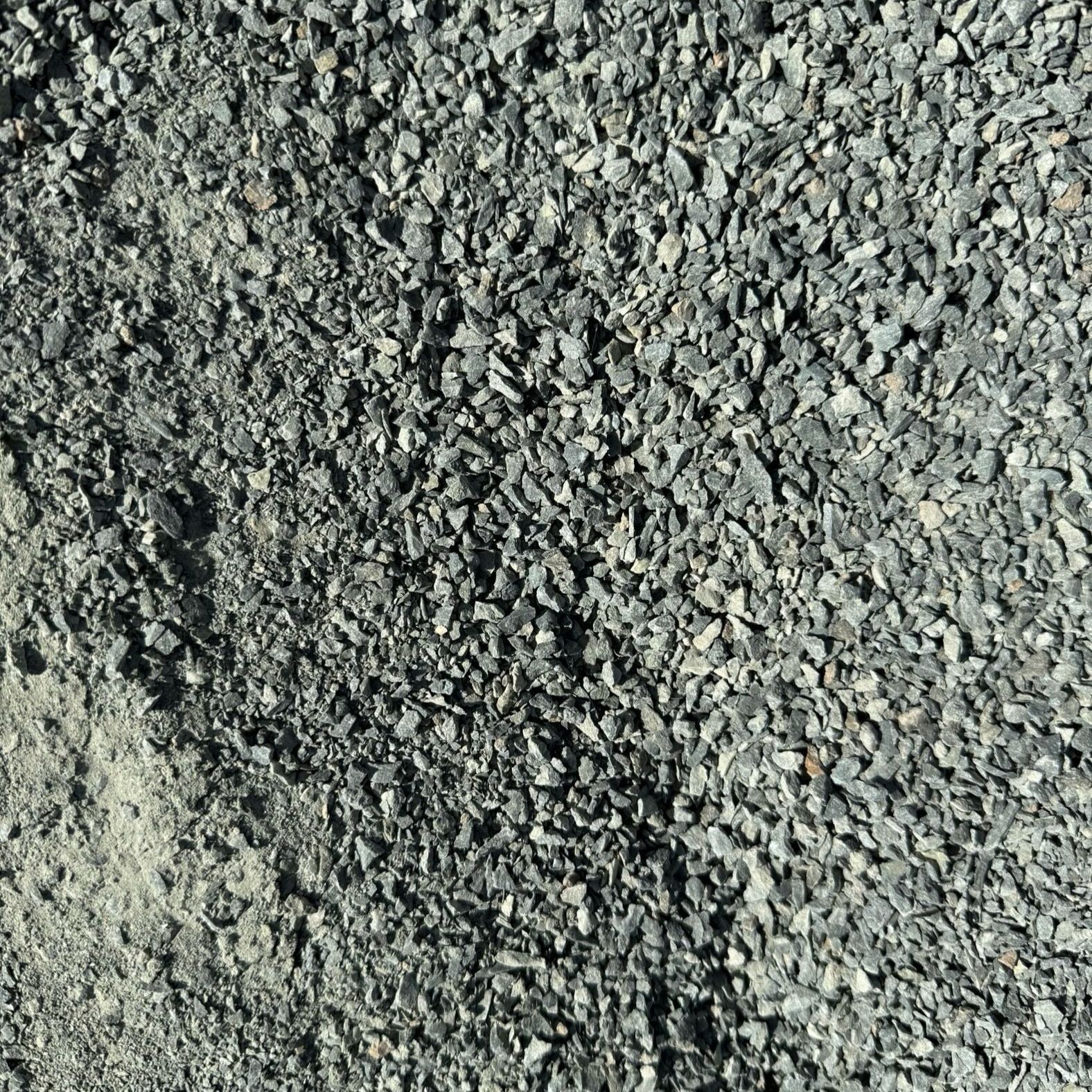 A pile of gravel is sitting on the ground.