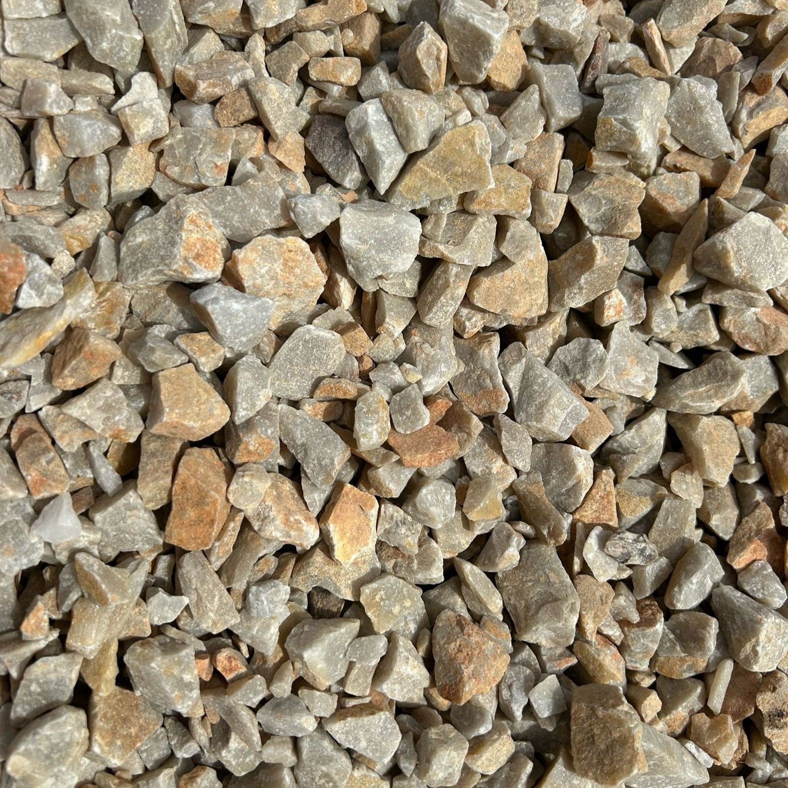 A pile of gravel is sitting on the ground.