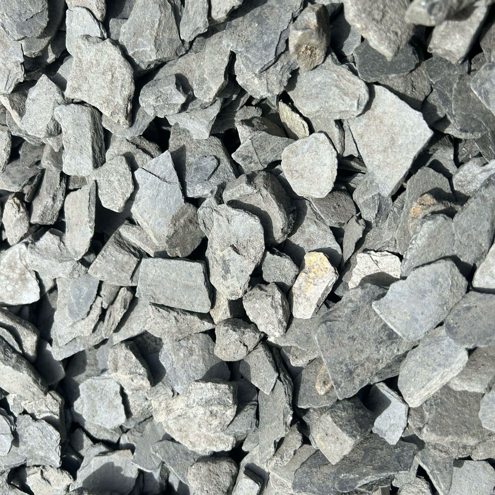 A pile of gray gravel is sitting on the ground