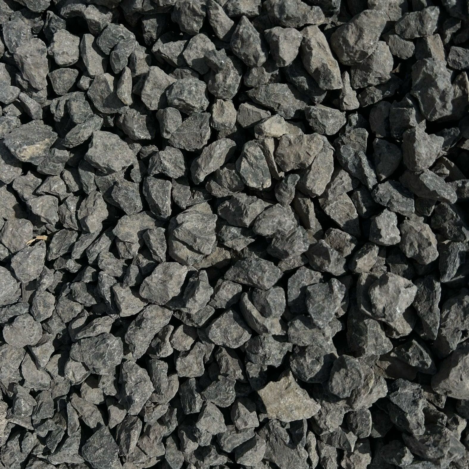 A pile of black gravel is sitting on the ground