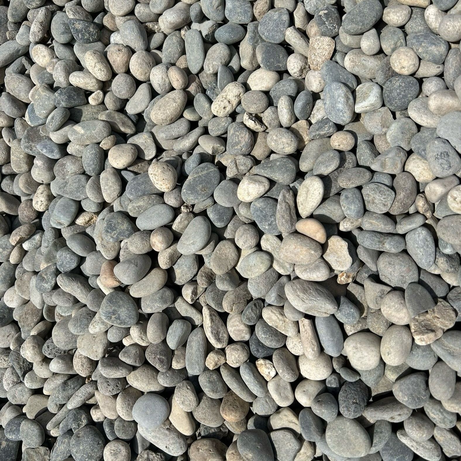 A pile of rocks is sitting on the ground.