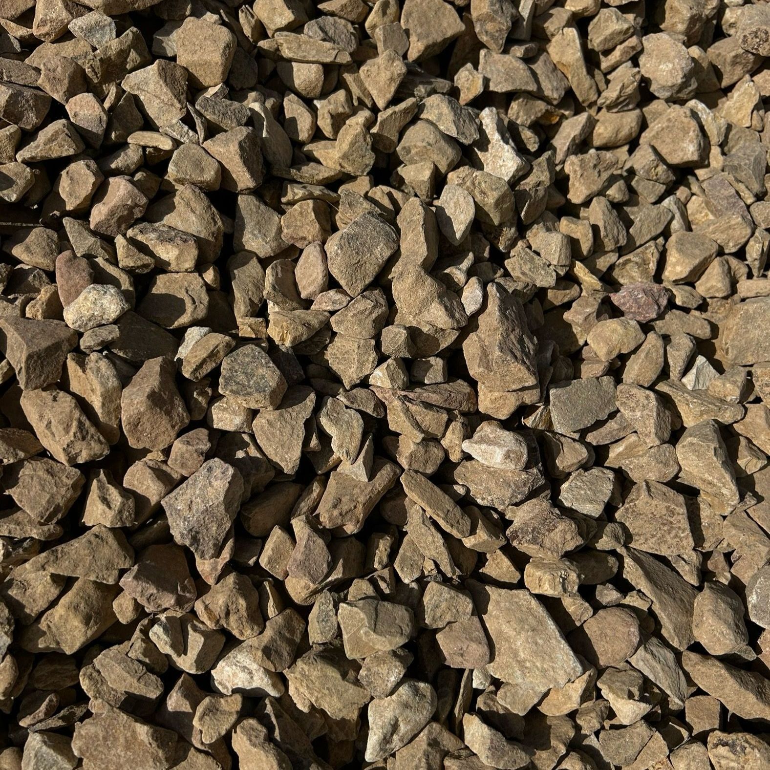 A pile of brown gravel is sitting on the ground
