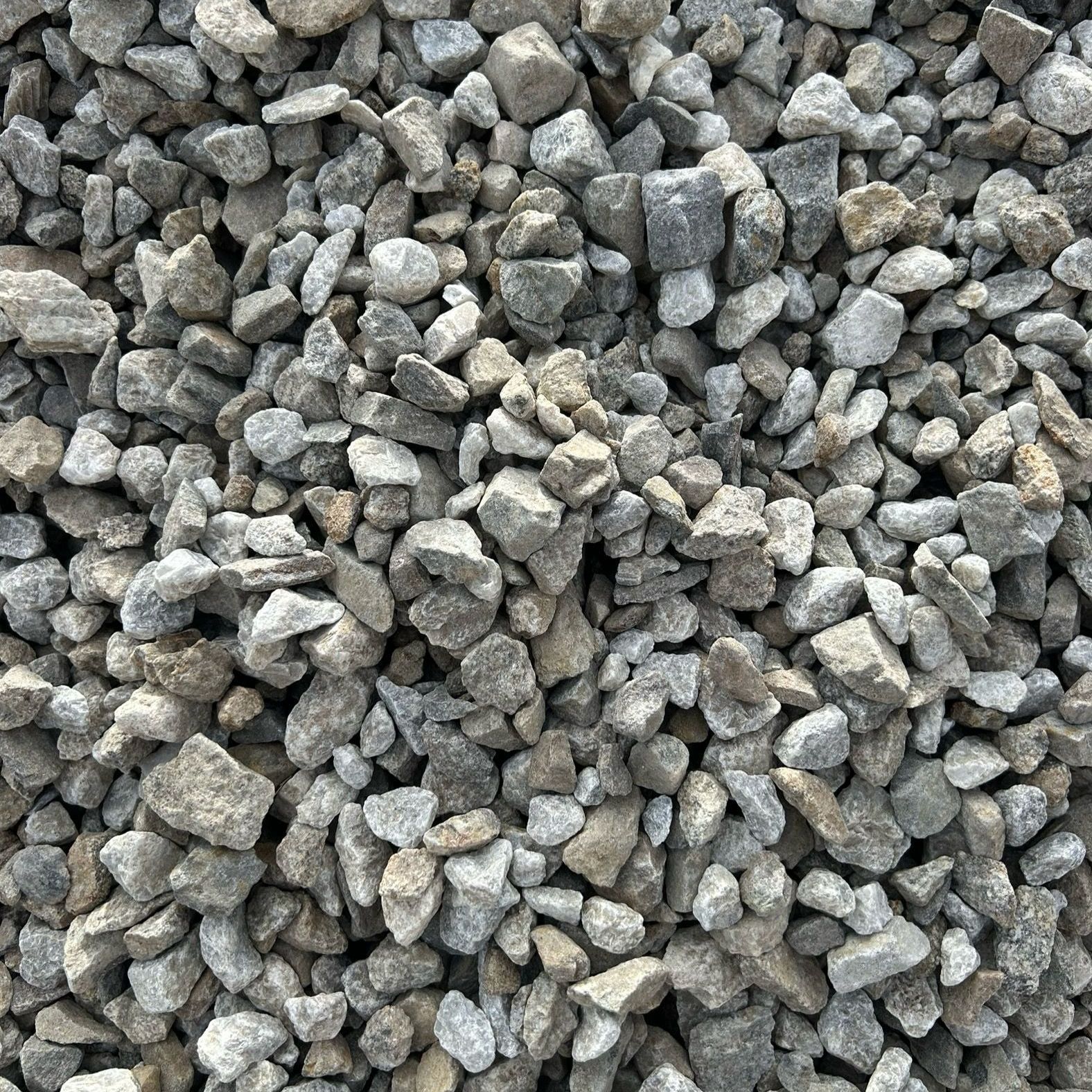 A pile of gravel is sitting on the ground.