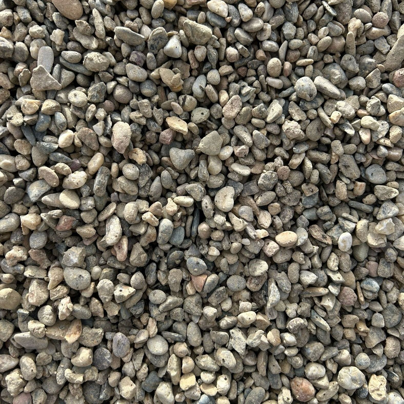 A pile of gravel is sitting on the ground.