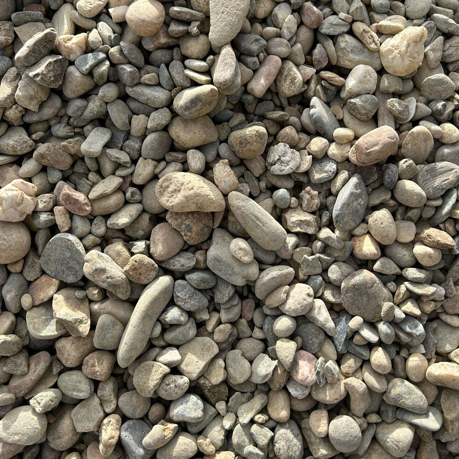 A pile of rocks is sitting on the ground.