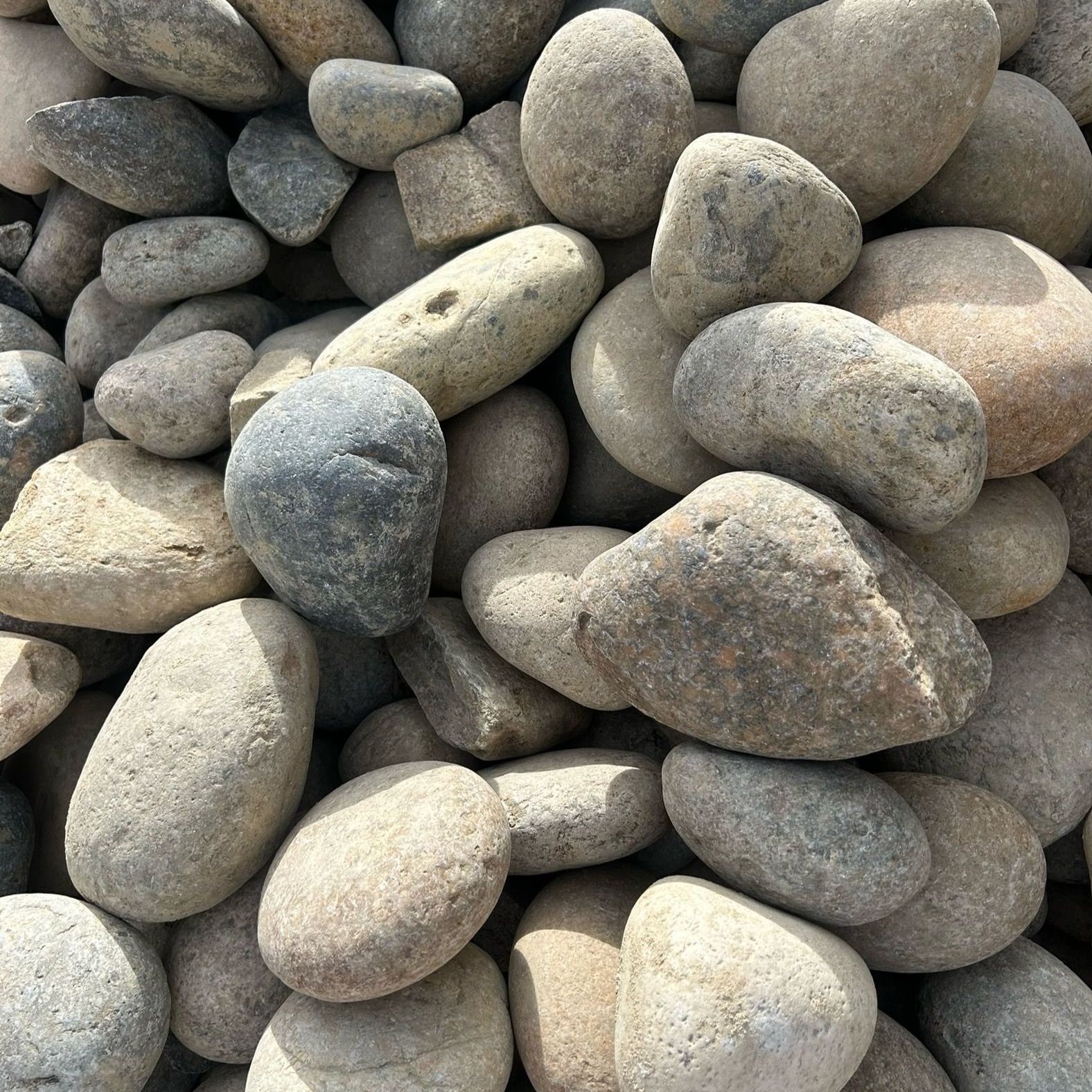 A pile of rocks with a blue rock in the middle