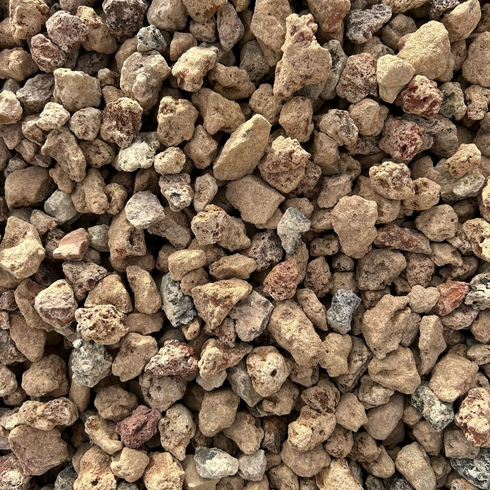 A pile of brown gravel is sitting on the ground.