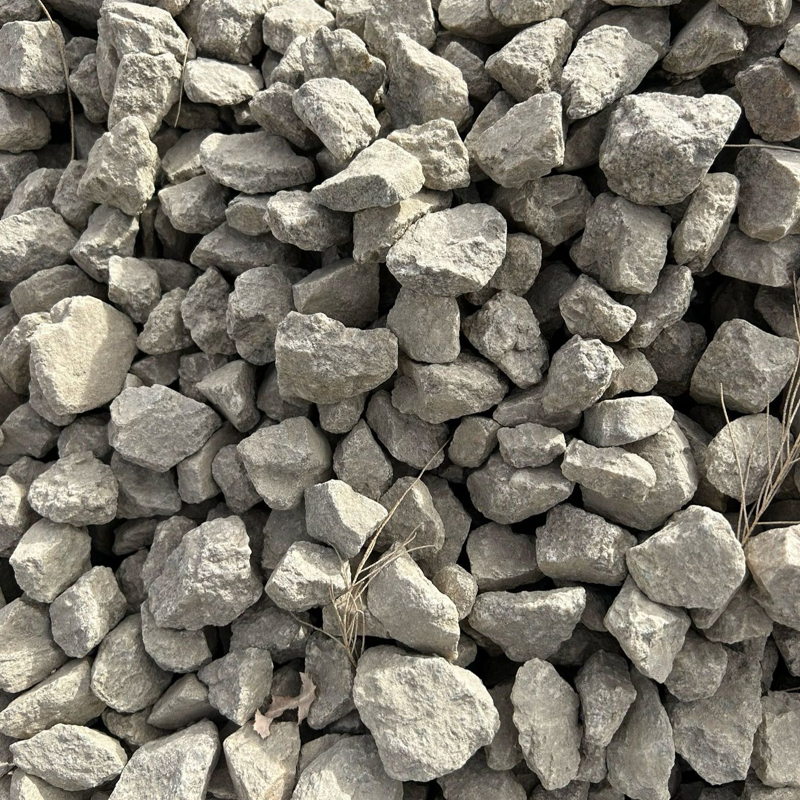 A pile of rocks is sitting on the ground.