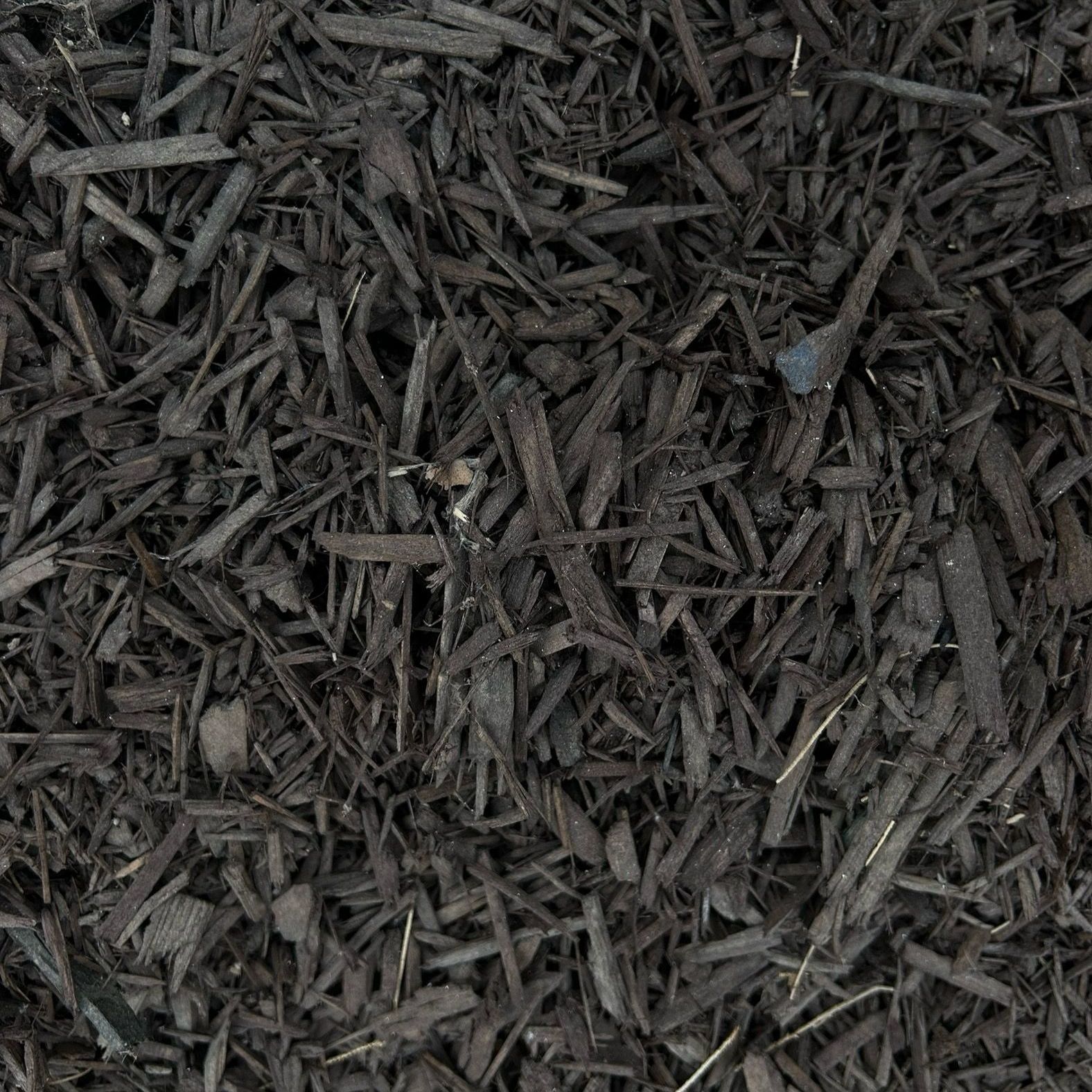A close up of a pile of black mulch.