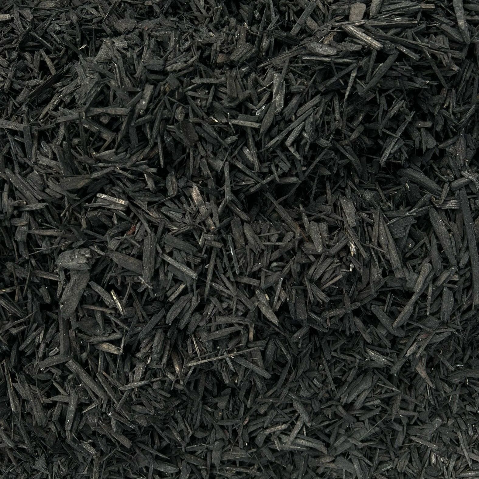 A close up of a pile of black mulch.