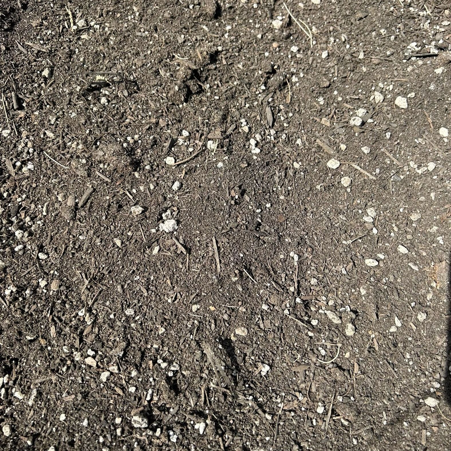 A pile of dirt with a lot of small rocks in it.