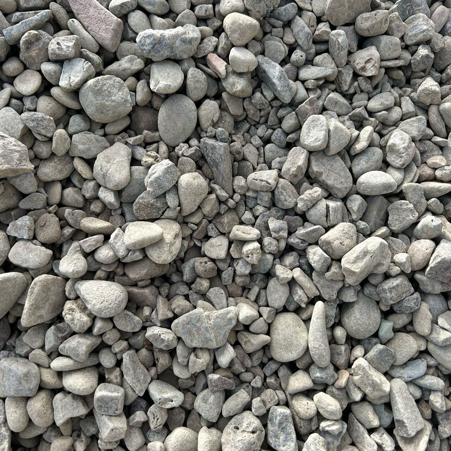 A pile of rocks is sitting on the ground.