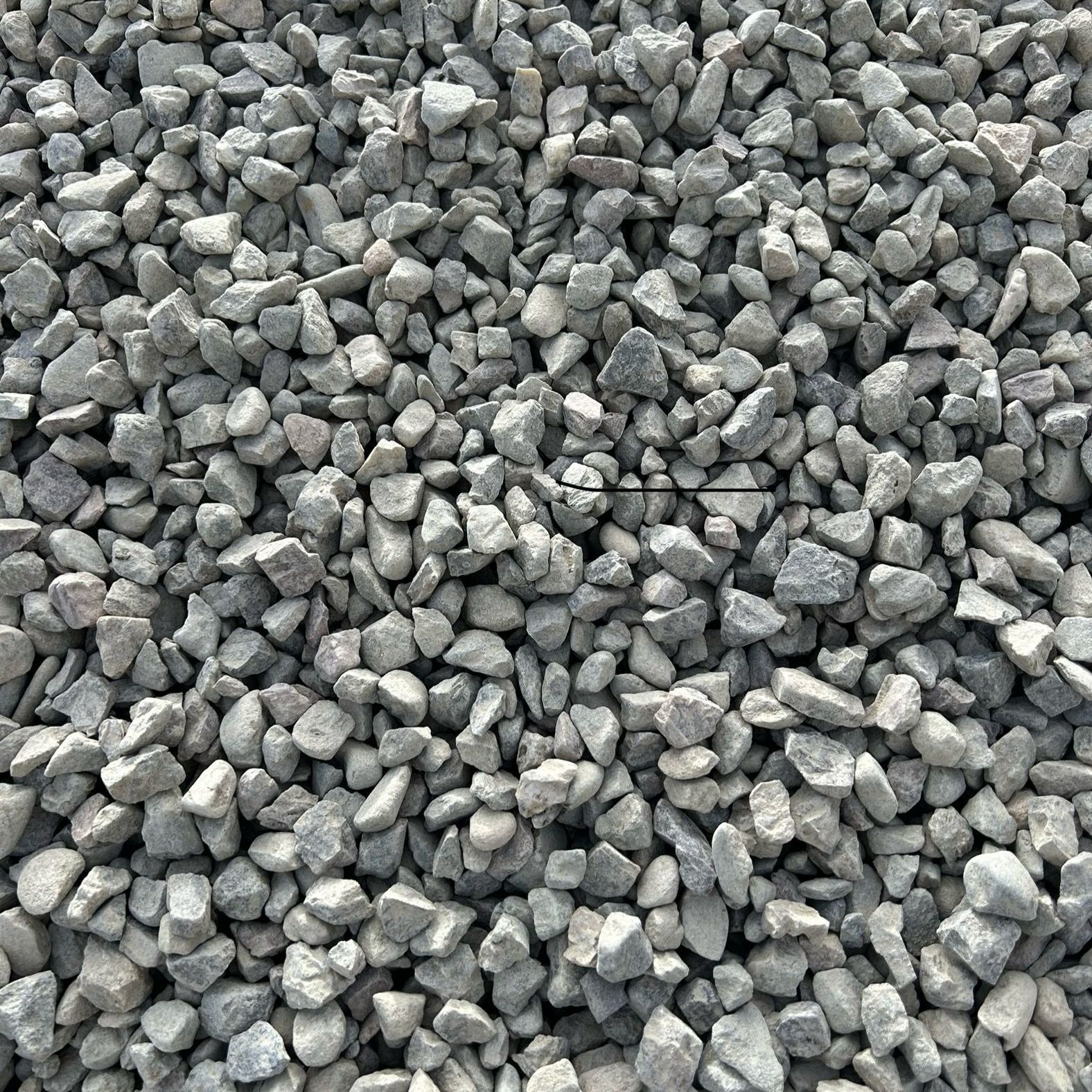 A pile of gravel is sitting on the ground.