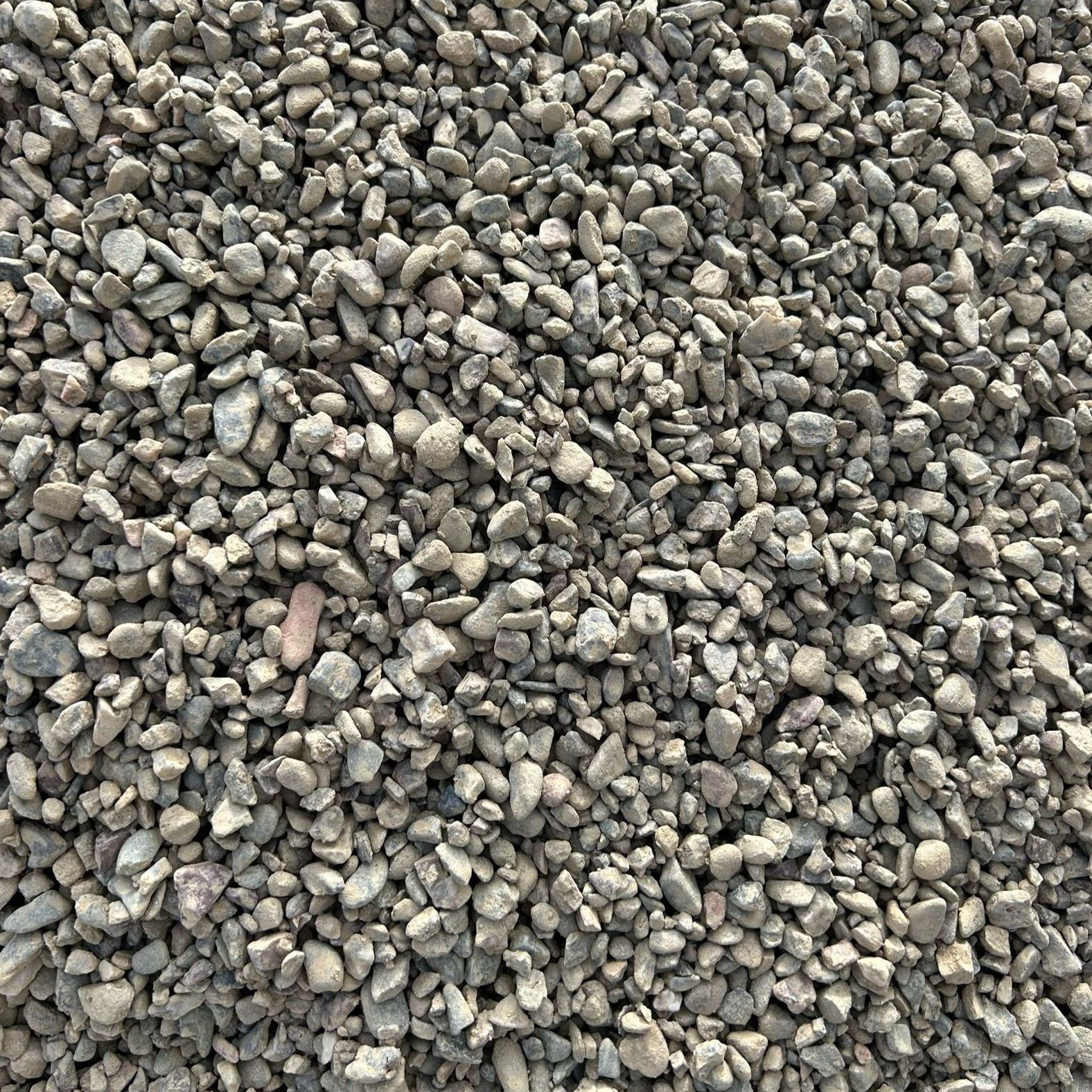 A pile of gravel is sitting on the ground.