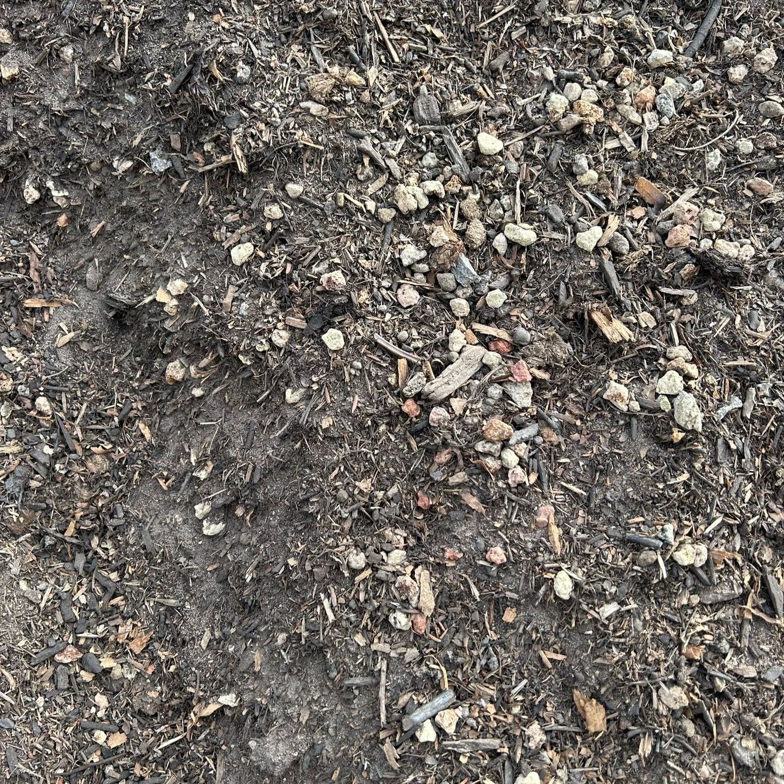 A pile of dirt and rocks on the ground.