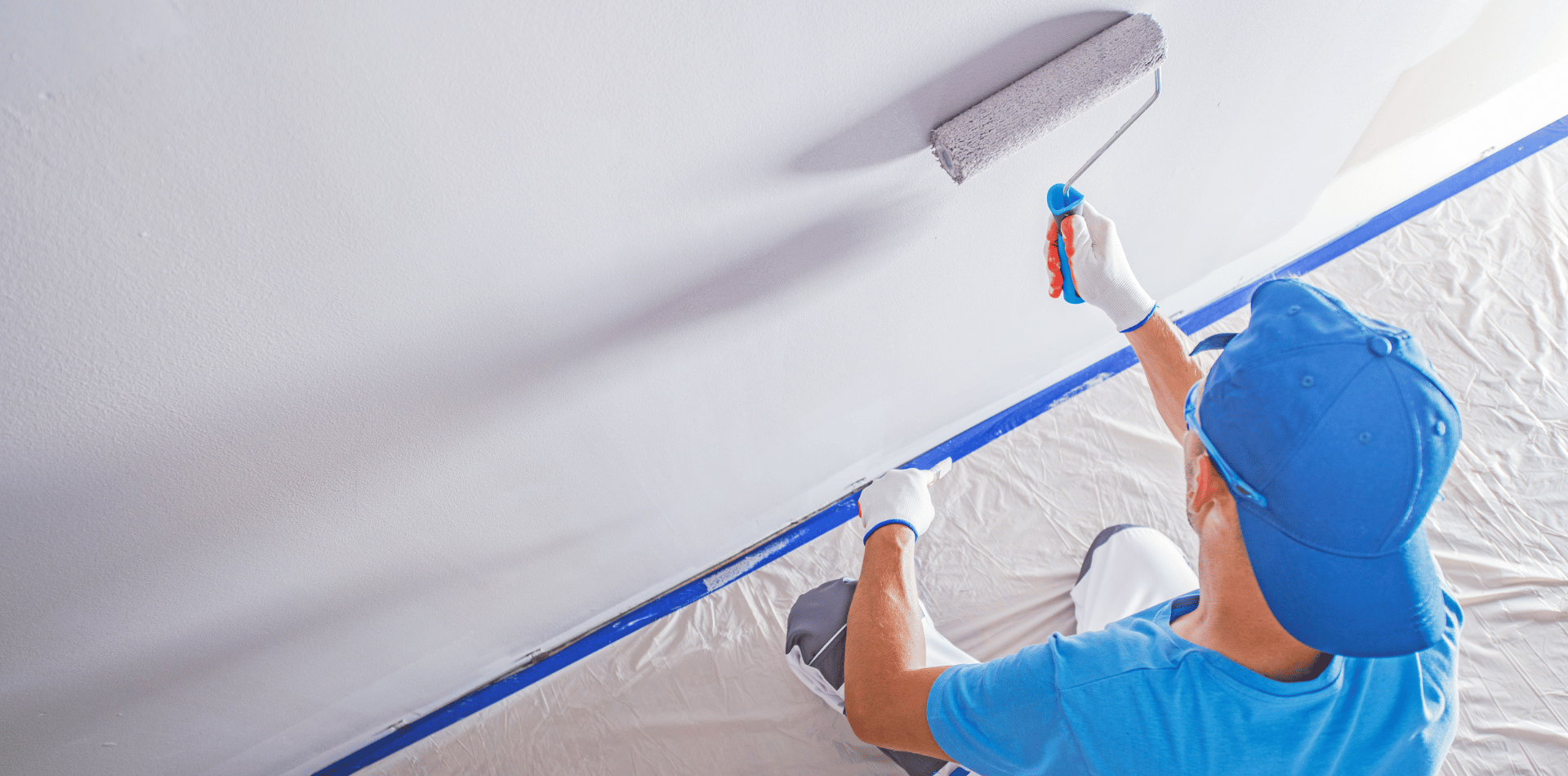 Professional Painter painting a hallway wall