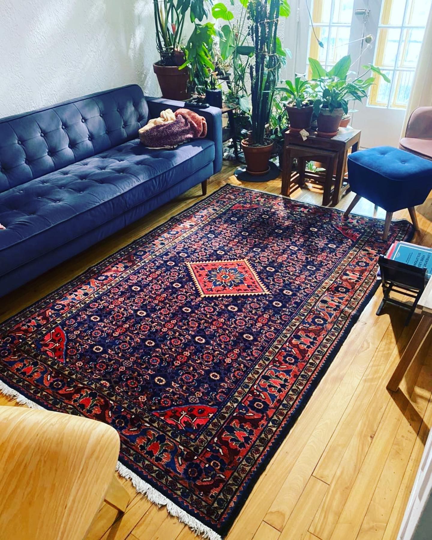 A living room with a couch and a rug on the floor.