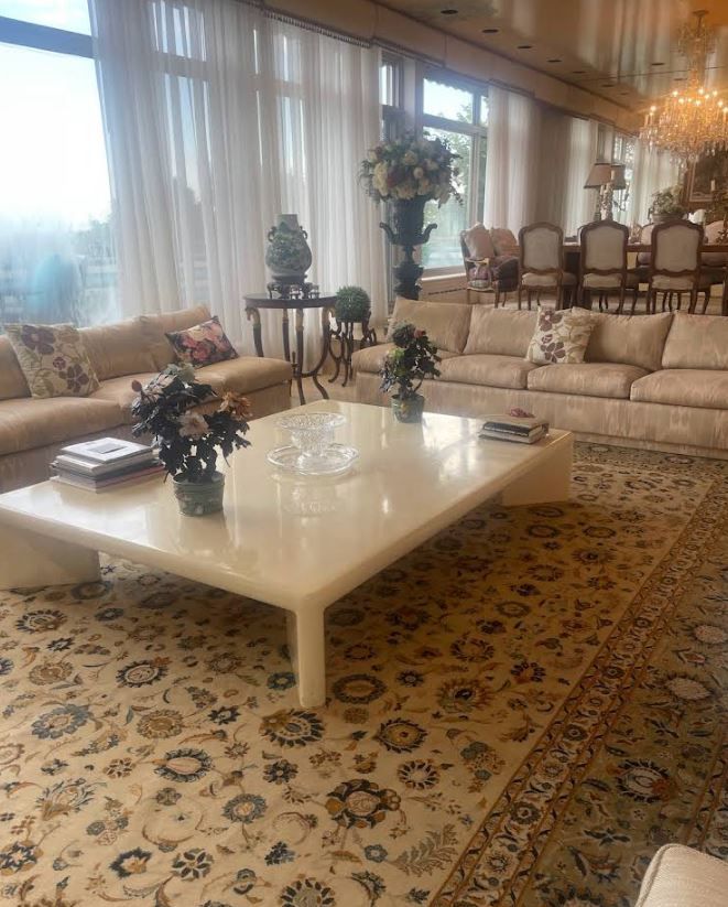 A living room filled with furniture and a rug.