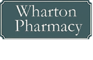 Sign for Wharton Pharmacy; white text on a teal background with a silver border.