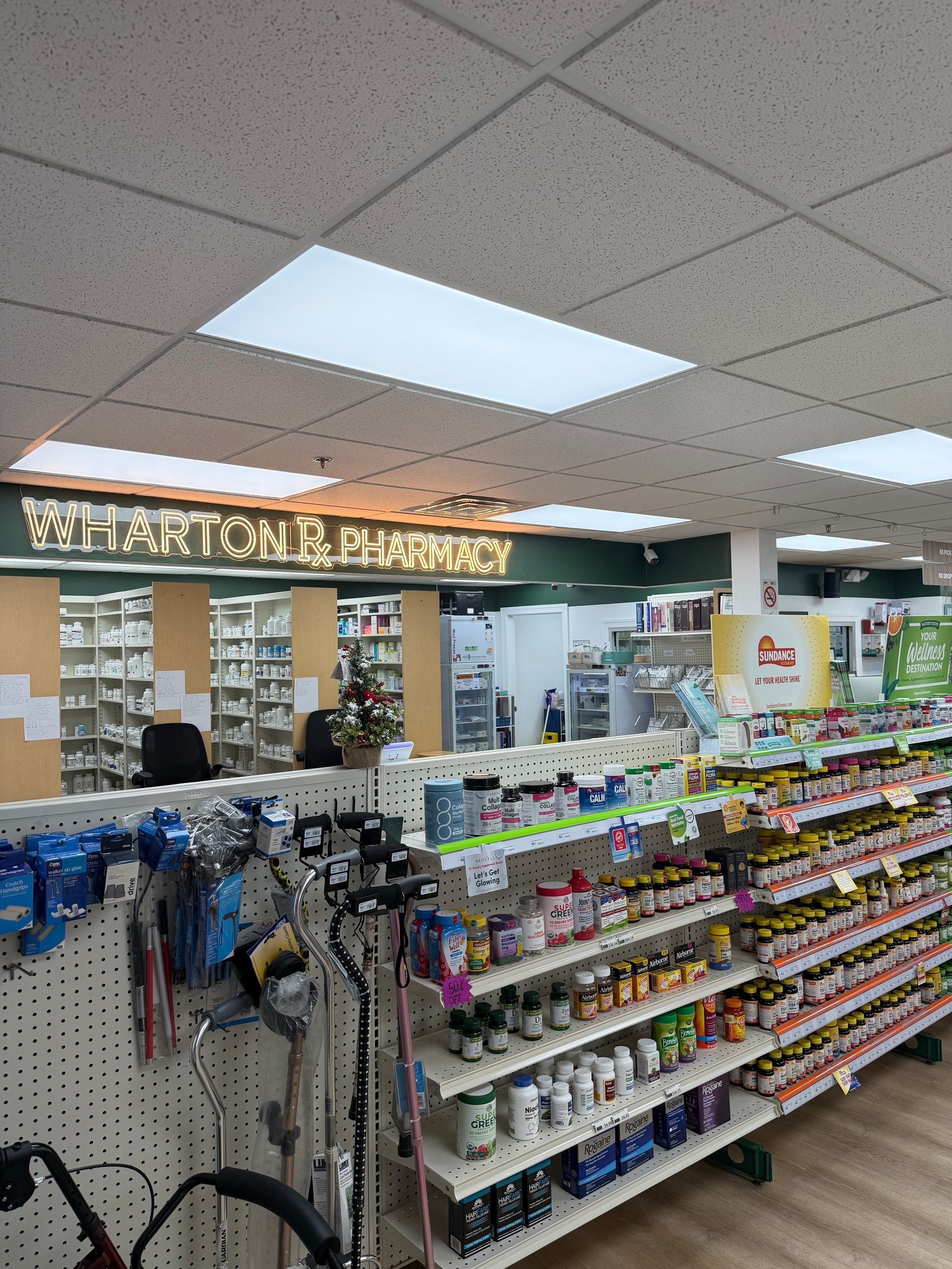 Interior view of Wharton Pharmacy with shelves, products, and a counter.