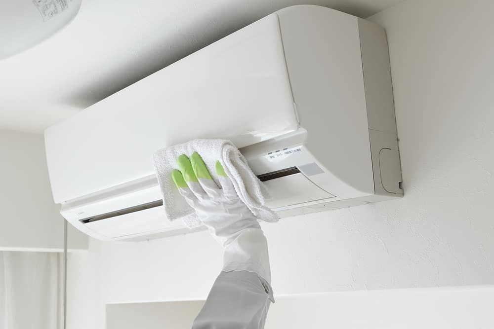Wiping an Air Con — Air Conditioning Services in Wollongong, NSW