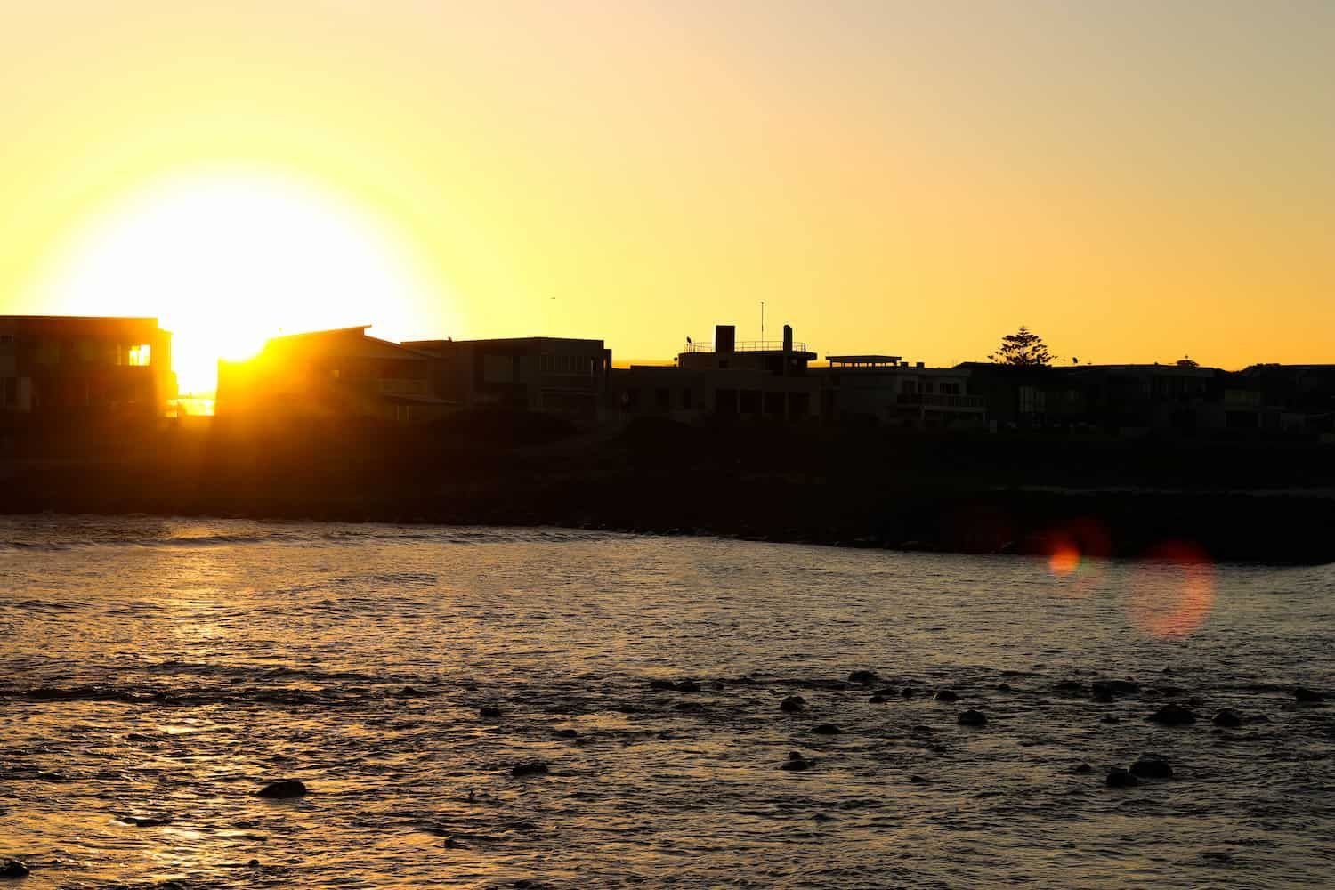Sunset Behind Buildings — Air Conditioning Services in Shellharbour, NSW