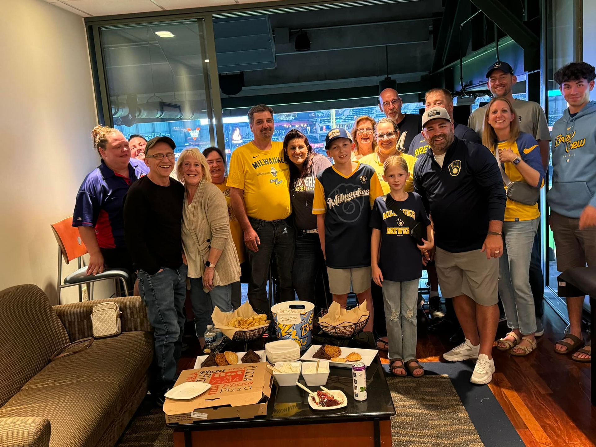 A group of people are posing for a picture in a living room.