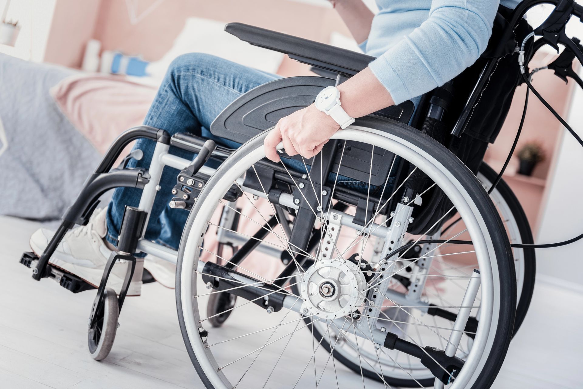 A woman is sitting in a wheelchair in a living room.