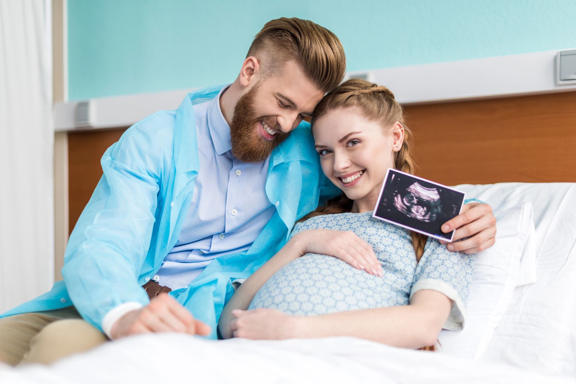 Pregnant Couple in Hospital Bed