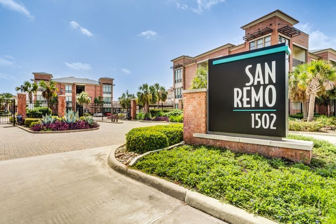 A large apartment building with a sign in front of it that says san remo.