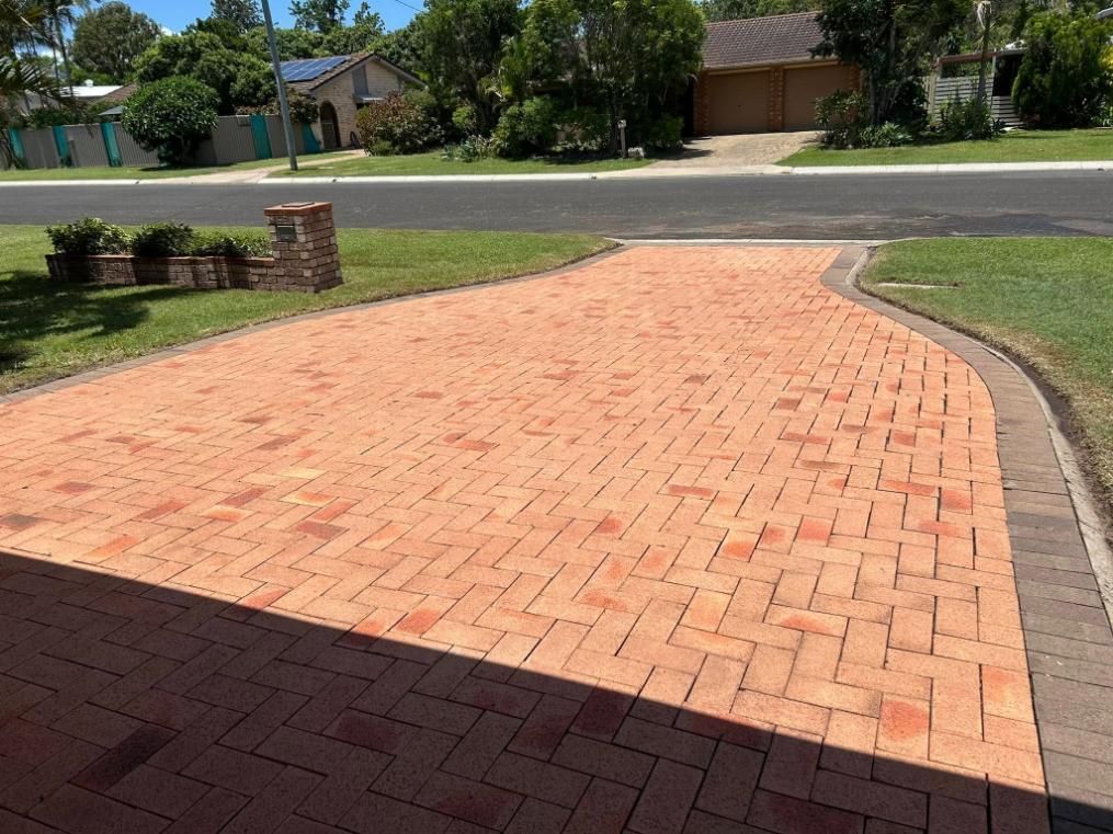 A Brick Driveway With a House in the Background — Derek's Dirty Deeds In Burrum Heads, QLD