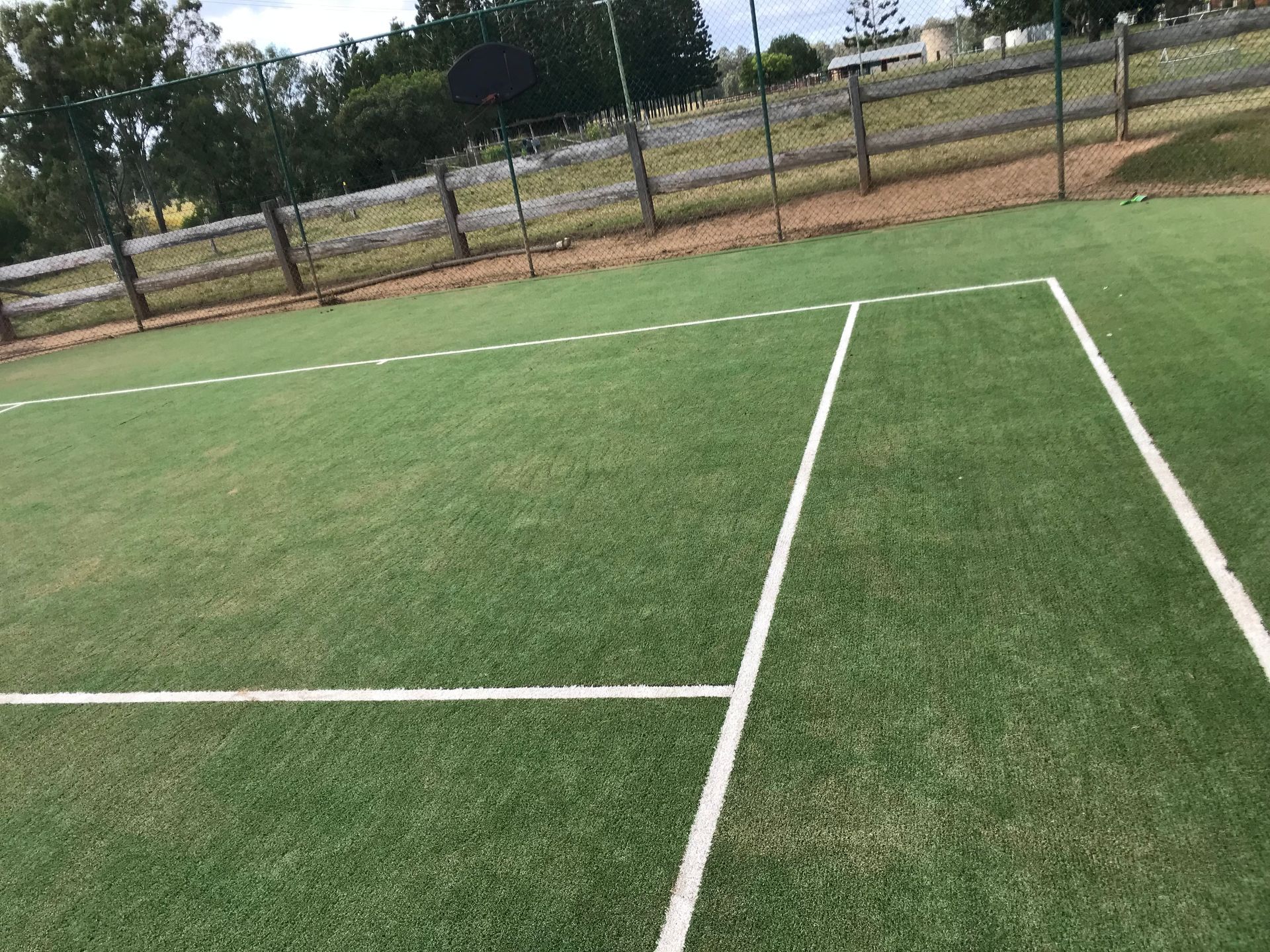 A Clean Tennis Court With a White Line After Cleaned by a High Pressure Water — Derek's Dirty Deeds In Maryborough, QLD