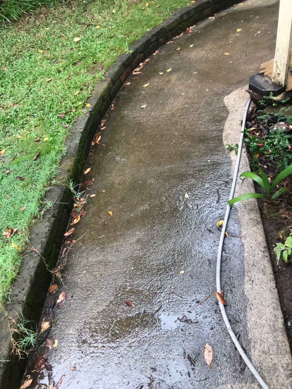 A Concrete Walkway With a Hose Attached to It — Derek's Dirty Deeds In Booral, QLD