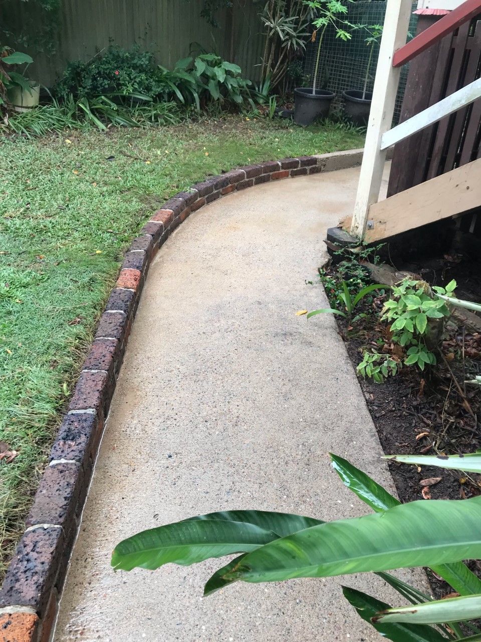 A Concrete Walkway Leading to a House With a Brick Border — Derek's Dirty Deeds In Booral, QLD
