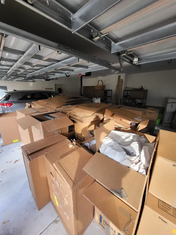 A garage filled with lots of cardboard boxes
