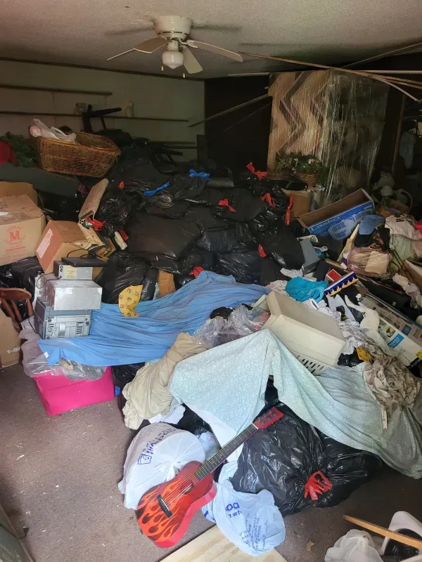 A room filled with lots of trash bags and boxes