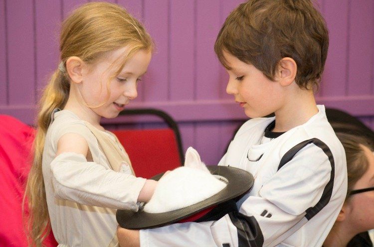 Children trying out magic tricks