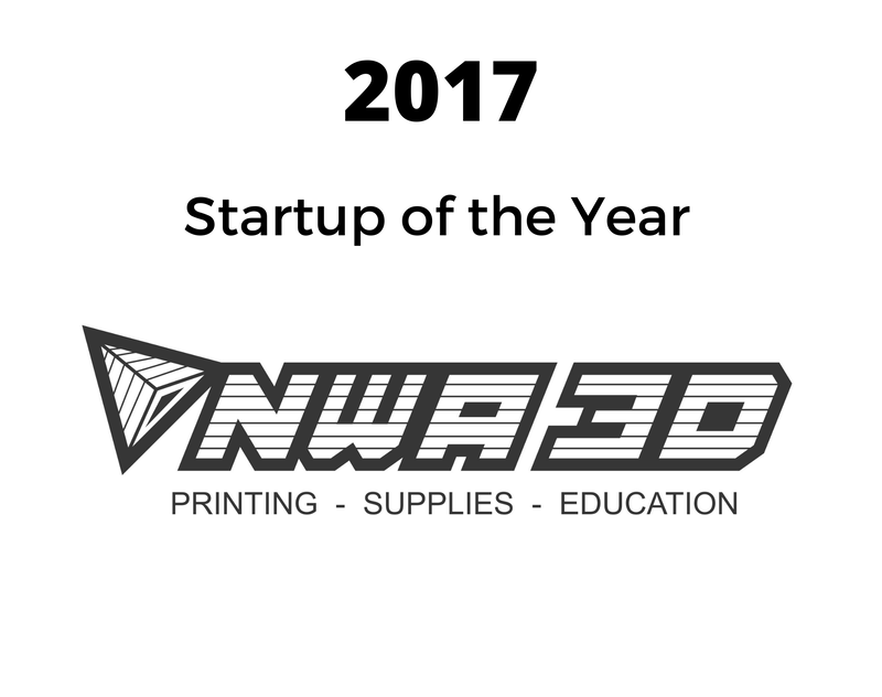 a black and white logo for a company named startup of the year .