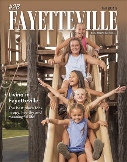 a group of young girls are riding down a slide on the cover of a magazine .