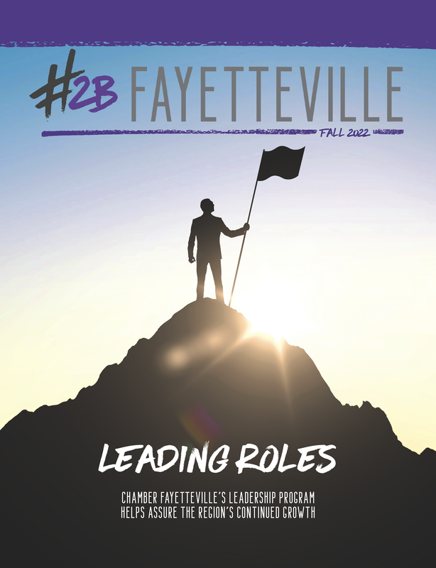 a man is standing on top of a mountain holding a flag .