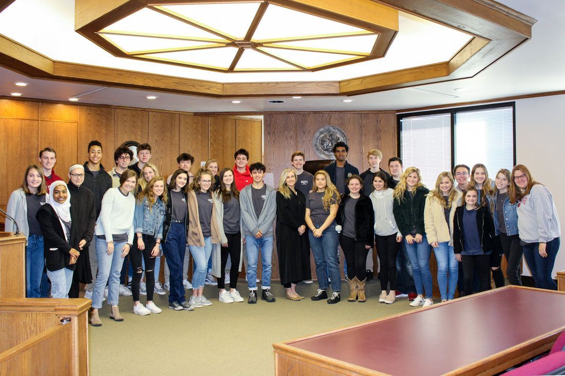a group of people are posing for a picture in a room .