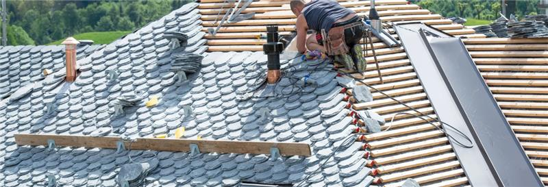 Slate roof against a clear blue sky.