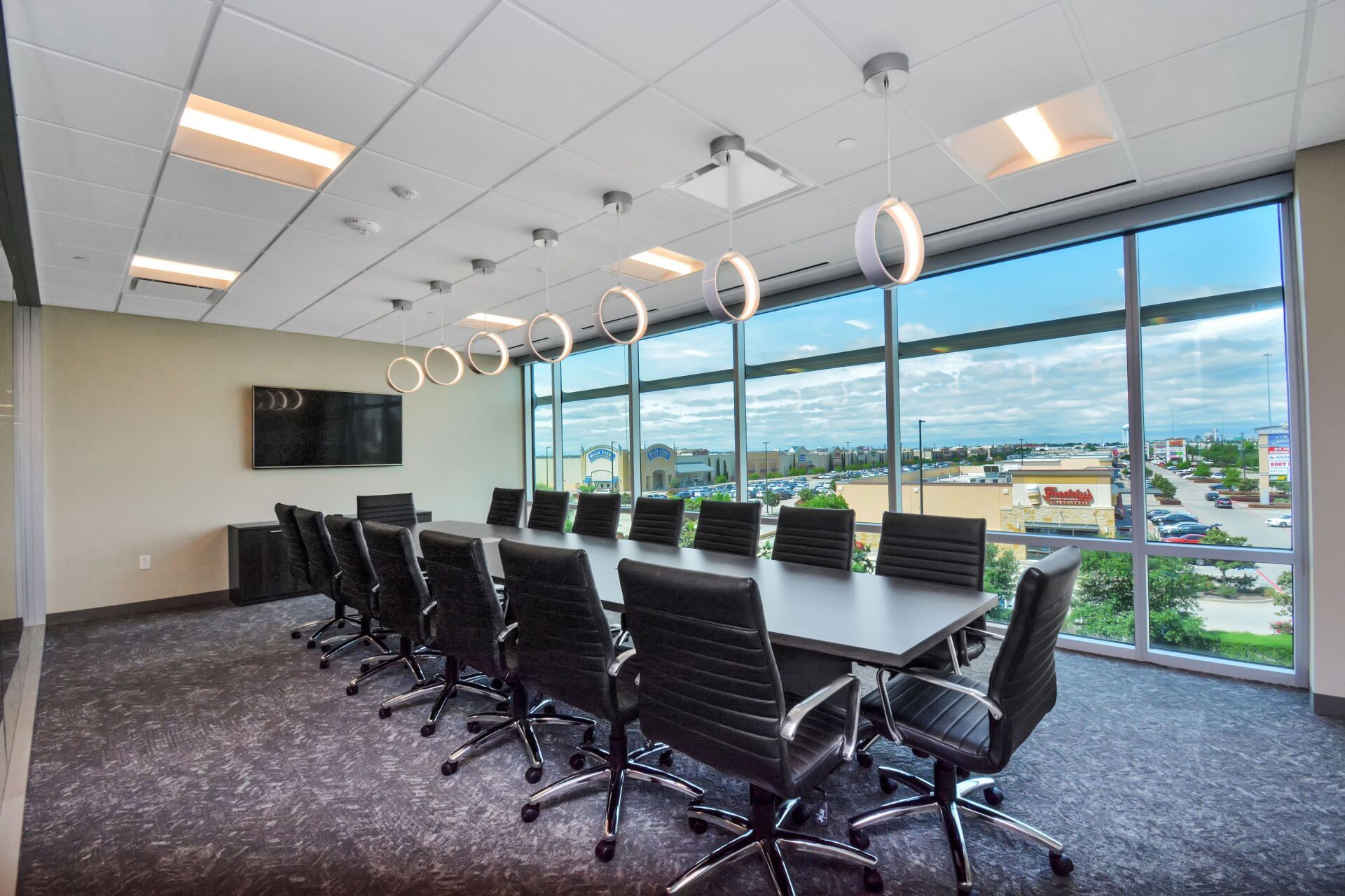 A conference room with a long table and chairs