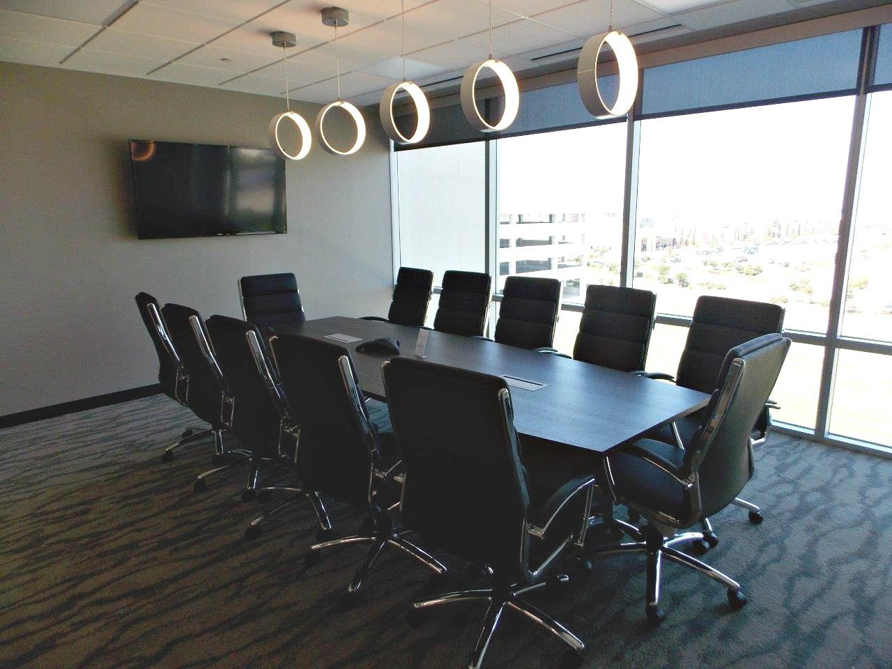 A conference room with a long table and chairs