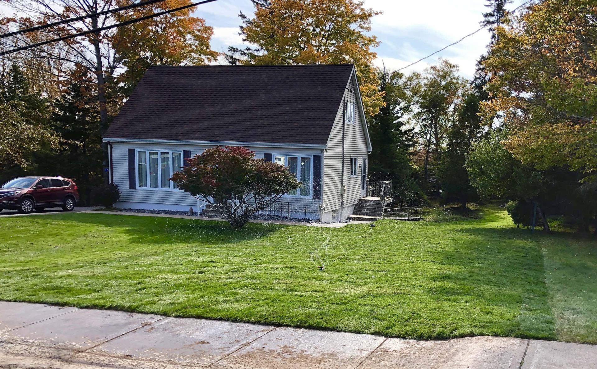 A small house with a car parked in front of it