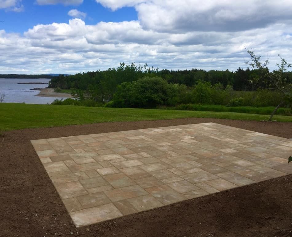 A patio with a view of a lake in the background